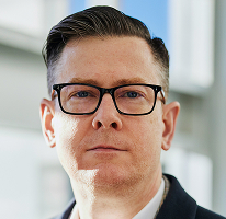 Portrait of Alexander Hughes, CEO and executive at a crypto trading company